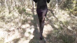 Walking on the wood wearing a black dress pantyhose heels