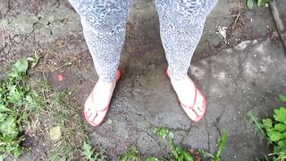 Pissing standing and farting, teenager girl in the yard of an abandoned house.