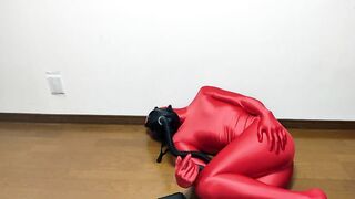 Respiratory control with gas mask on red zentai