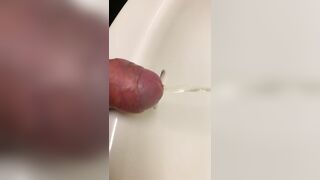 Close up dick peeing in sink