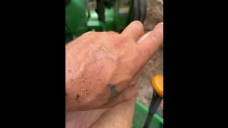 Dirty feet on tractor cutting wood