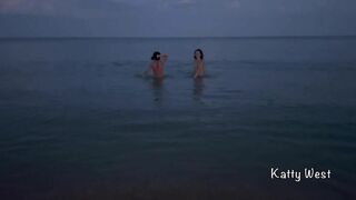 Two naked sluts swimming in the sea on a public beach