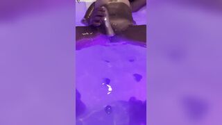 Jasmine masturbates the clitoris with a waterproof sex toy in the jaccuzy