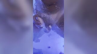 Jasmine masturbates the clitoris with a waterproof sex toy in the jaccuzy