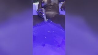 Jasmine masturbates the clitoris with a waterproof sex toy in the jaccuzy