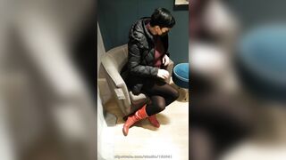 Fully dressed crossed legs orgasm in a store