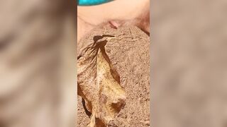 Girl Pissing on a large leaf that has fallen from a tree to the ground in Nature Park