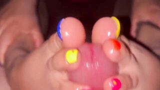 Tickling teasing colourful neon toes rubbing on a big head