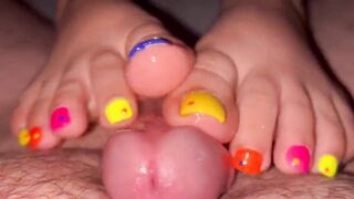 Tickling teasing colourful neon toes rubbing on a big head