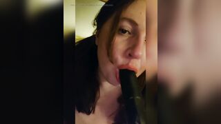 Sucking a big black dildo