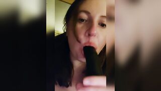 Sucking a big black dildo