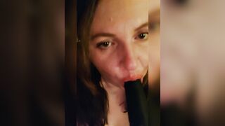 Sucking a big black dildo