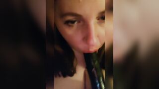 Sucking a big black dildo