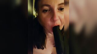 Sucking a big black dildo