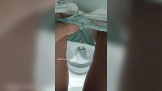 Girl peeing in the public toilet